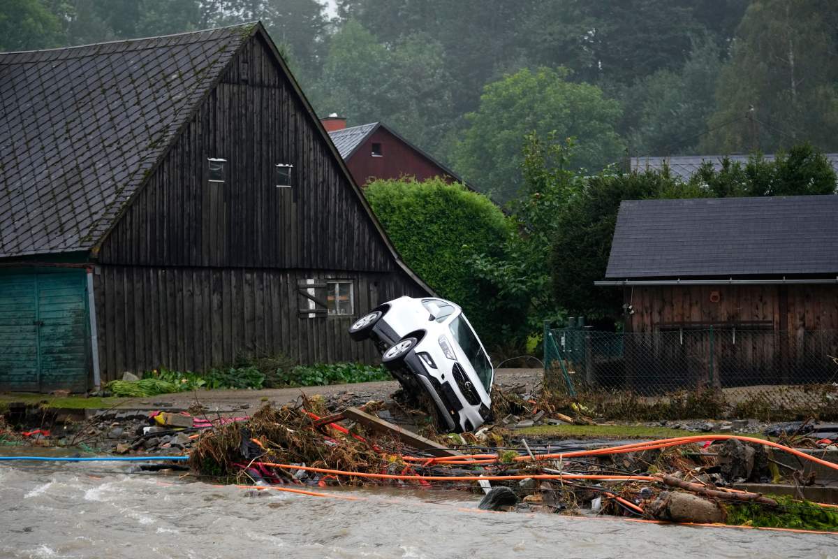 A car is stucked on a river bank after recent floods in Domasov, Czech Republic