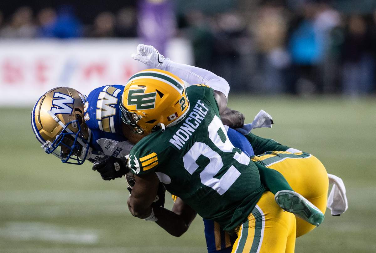 Winnipeg Blue Bombers' Nic Demski (left) is tackled by Edmonton Elks' Derrick Moncrief (29) during second half CFL action in Edmonton, on Saturday September 21, 2024.