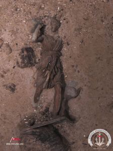 The statue of Diana laying on the sandy seafloor.