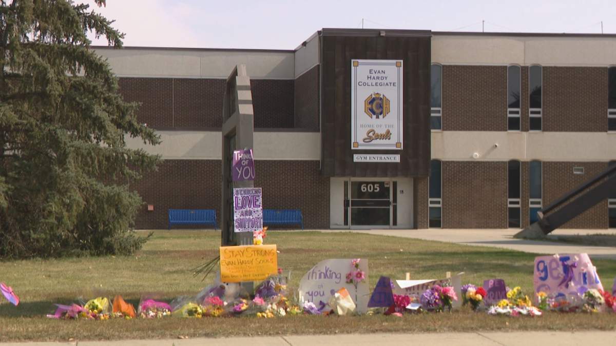 Flowers and signs of support left outside Evan Hardy Collegiate after a 15-year-old girl was lit on fire at school on Sept. 5, 2024.