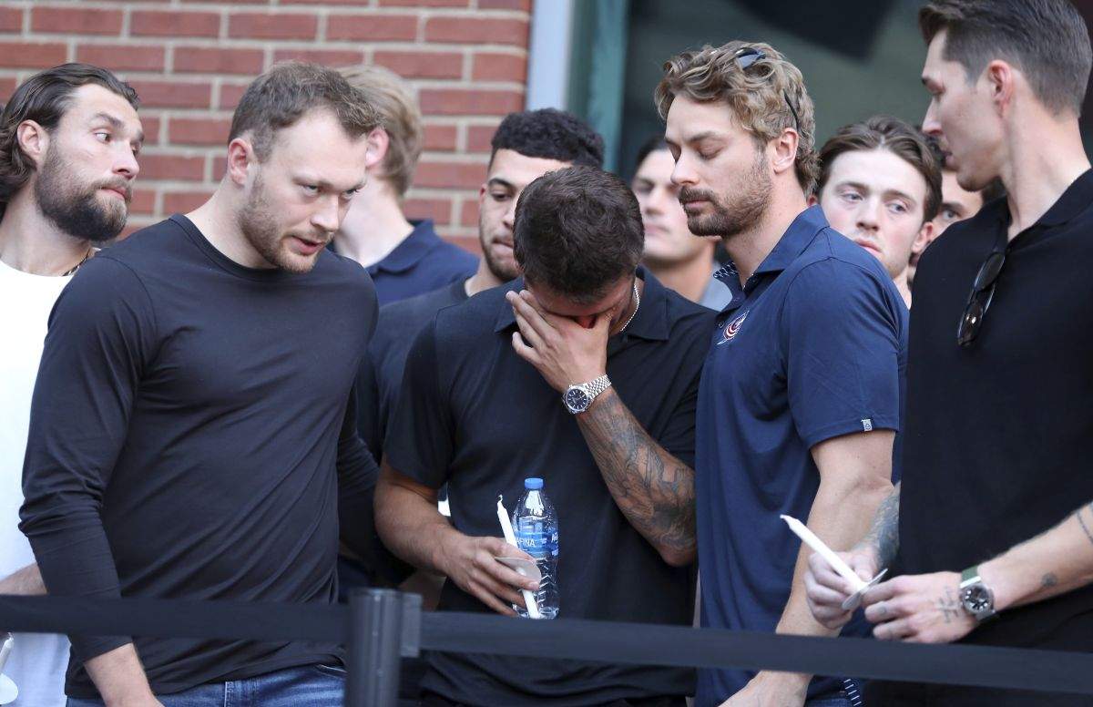 Columbus Blue Jackets player Cole Sillinger, centre, reacts during the candlelight vigil to honour Blue Jackets hockey player Johnny Gaudreau, outside of Nationwide Arena in Columbus, Ohio, Wednesday, Sept. 4, 2024. Gaudreau and his brother Matthew were killed by a motor vehicle last week while riding bicycles.