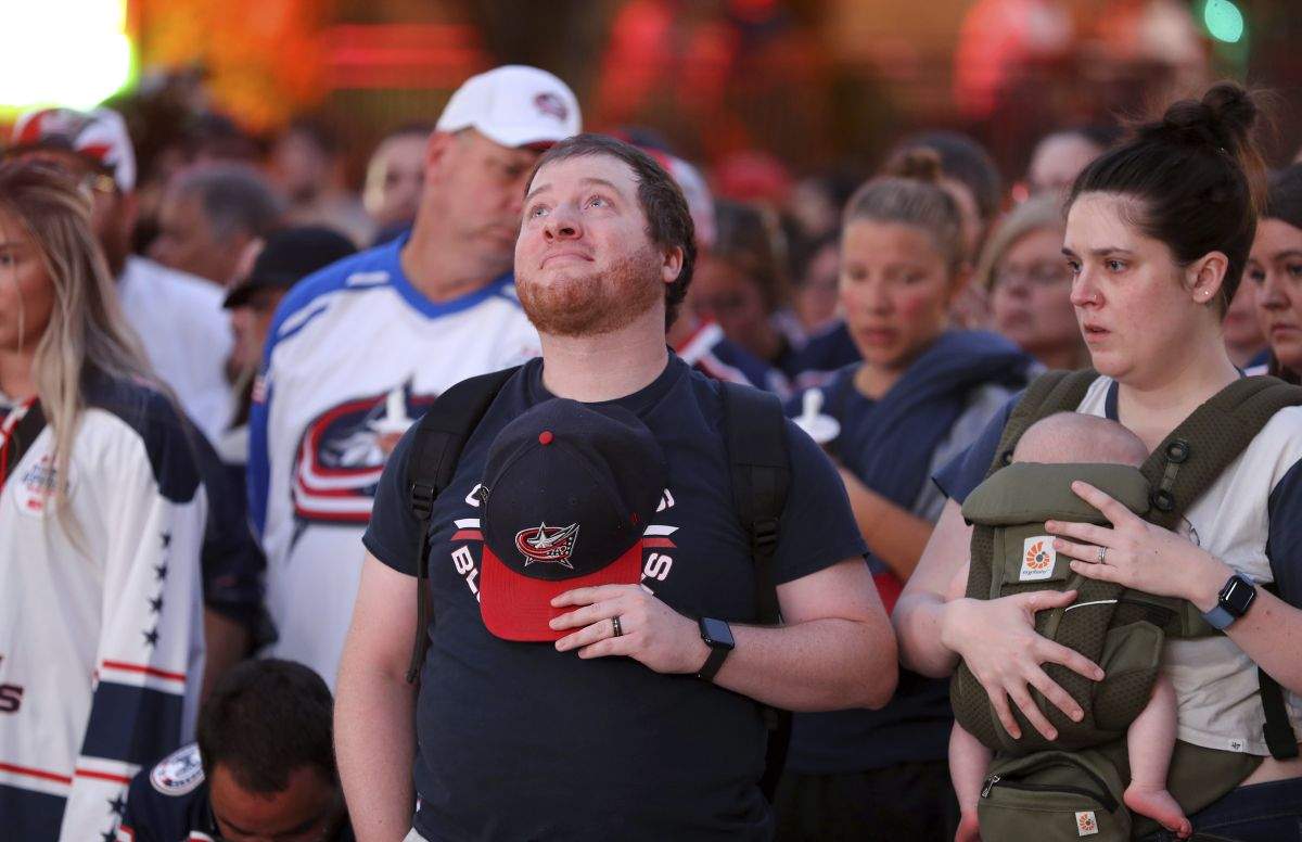 Columbus Blue Jackets fan Nathan Steele of Columbus, has a moment of silence during the candlelight vigil to honour Columbus Blue Jackets hockey player Johnny Gaudreau, outside of Nationwide Arena in Columbus, Ohio, Wednesday, Sept. 4, 2024. Gaudreau and his brother Matthew were killed by a motor vehicle last week while riding bicycles.