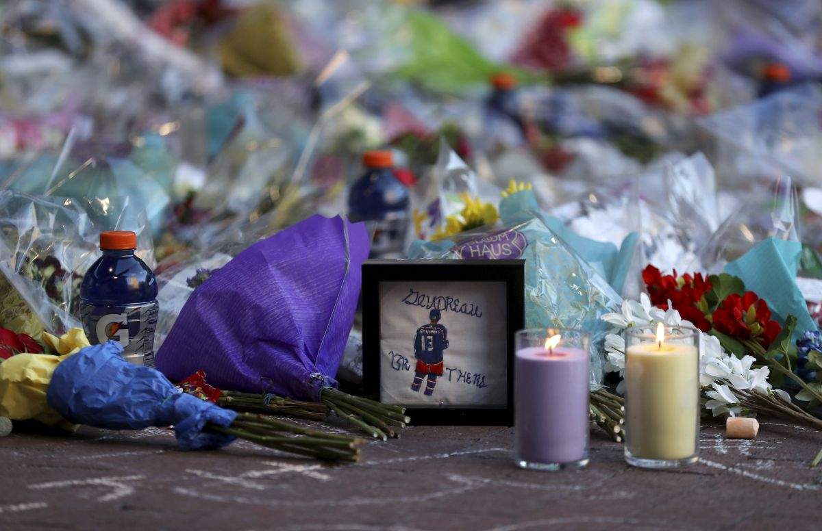 Fans leave mementos as part of the candlelight vigil to honour Columbus Blue Jackets hockey player Johnny Gaudreau, Wednesday, Sept. 4, 2024, outside of Nationwide Arena in Columbus, Ohio. Gaudreau and his brother Matthew were killed by a motor vehicle last week while riding bicycles.