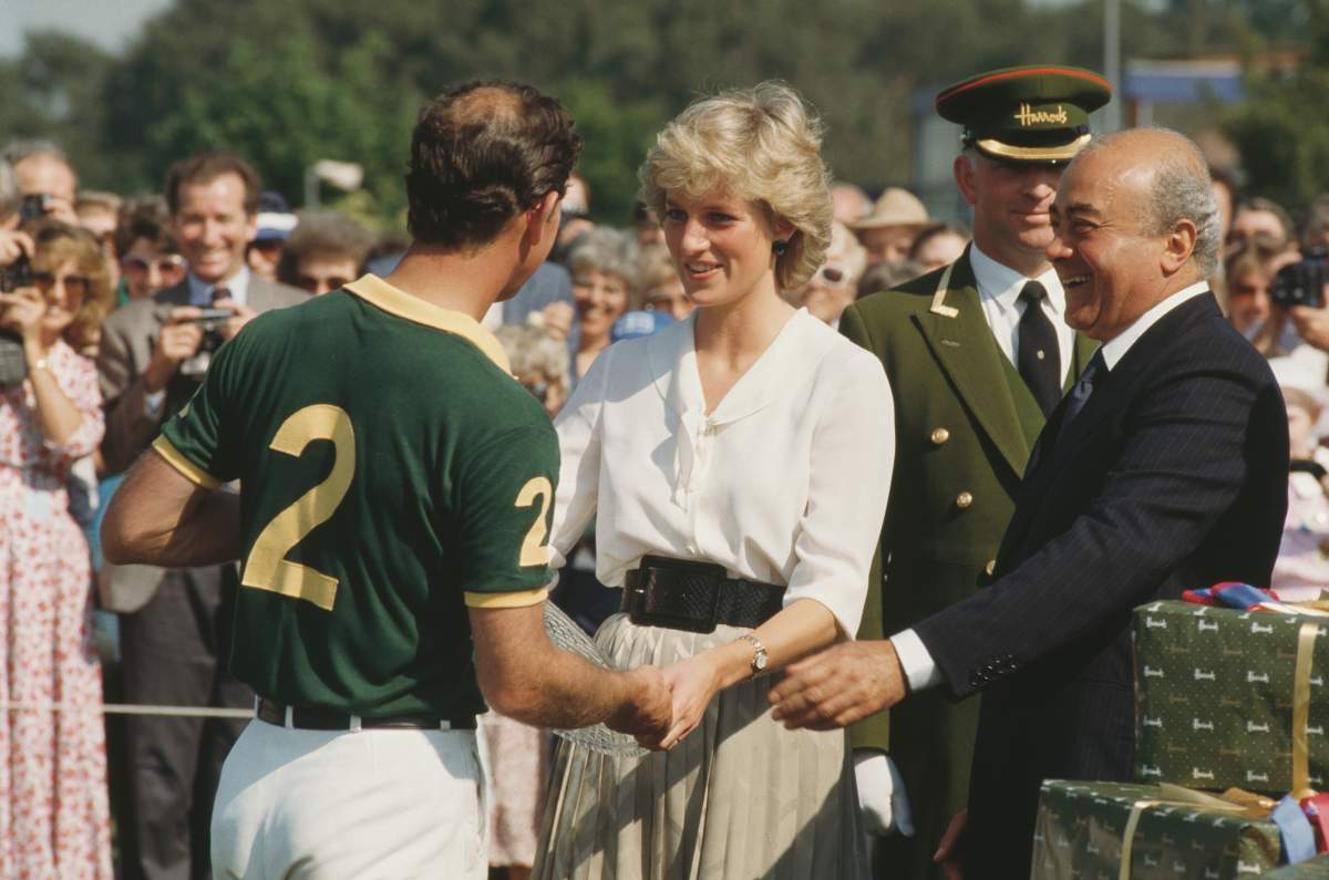 Mohamed Al-Fayed stands beside Diana, Princess of Wales, with Prince Charles during the Harrods Polo Cup at Smith's Lawn in Windsor, UK, July 1987.