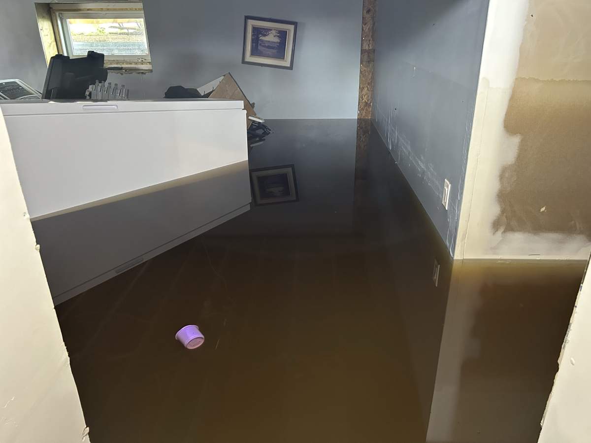 A freezer can be seen floating in Khristy Butler’s basement.