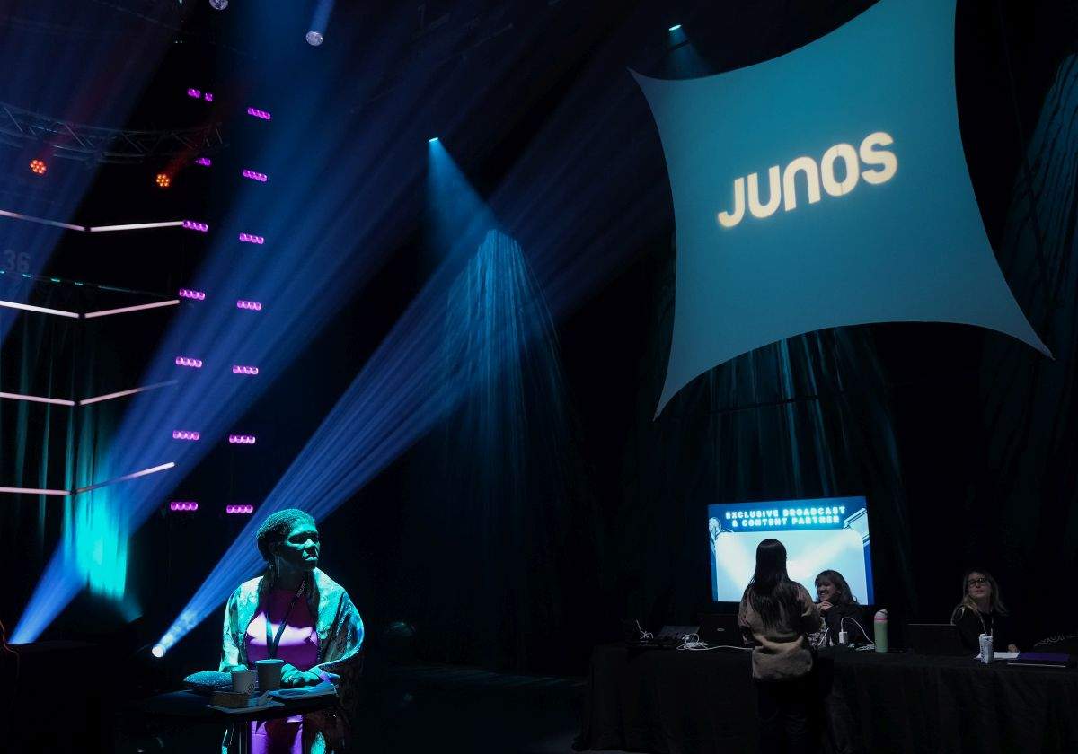 A woman awaits for the Juno Awards nominees announcement to start in Toronto on Tuesday, February 6, 2024.