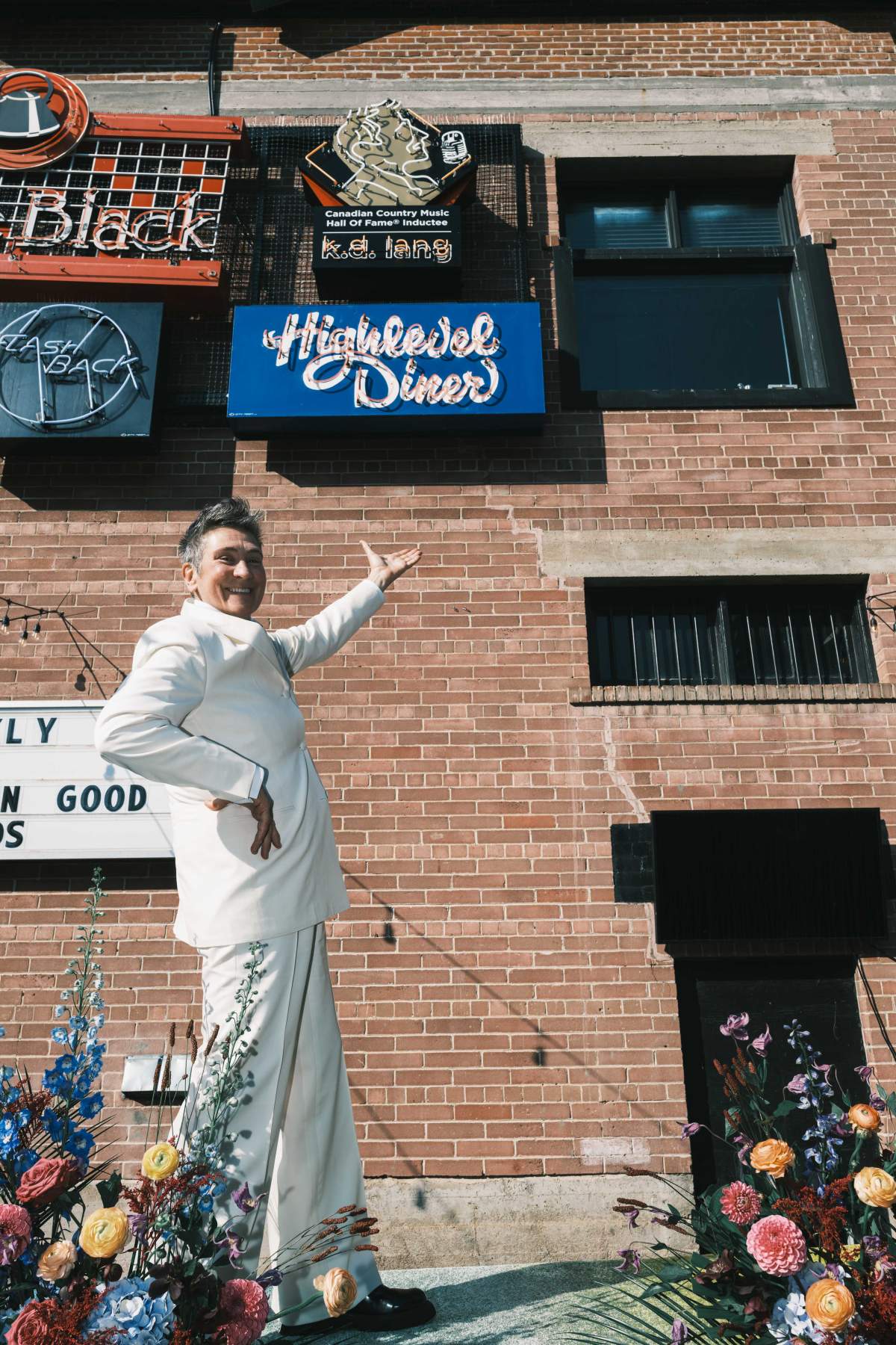 k.d. lang poses in front of a sign put up in her honour at Edmonton's Neon Sign Museum in this undated photo.