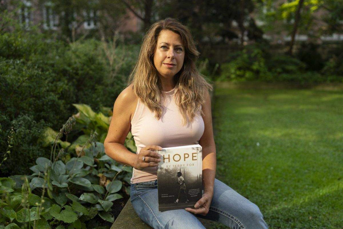 Barbara Adhiya, poses for a photo with her latest book titled, "Hope by Terry Fox" in Toronto on Sept. 13.