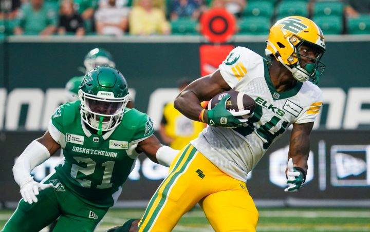 Edmonton Elks receiver Tevin Jones (84) runs the football past Saskatchewan Roughriders defensive back Nelson Lokombo (21) during the second half of CFL football action in Regina, on Saturday, August 3, 2024.