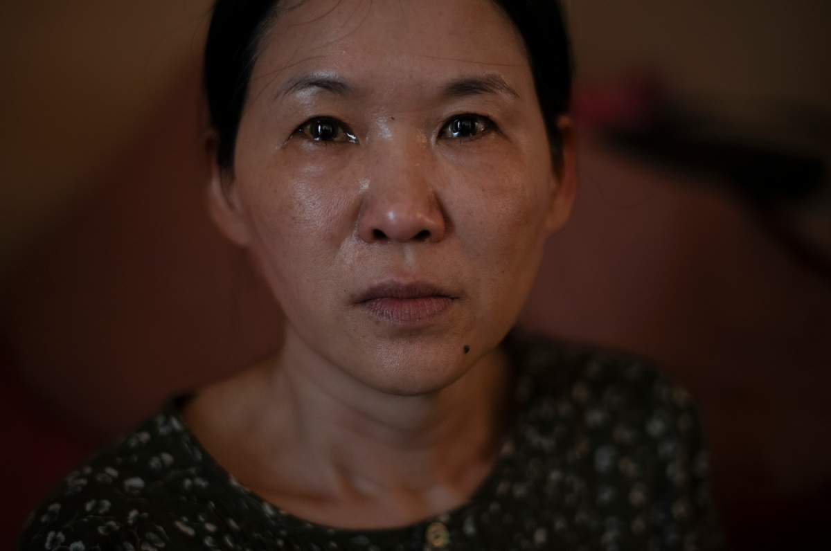 Yooree Kim, who was 11 when she was sent by an adoption agency to a couple in France, sits for a portrait as tears well up in her eyes in her apartment in Seoul, South Korea, Sunday, May 19, 2024. (AP Photo/Jae C. Hong)