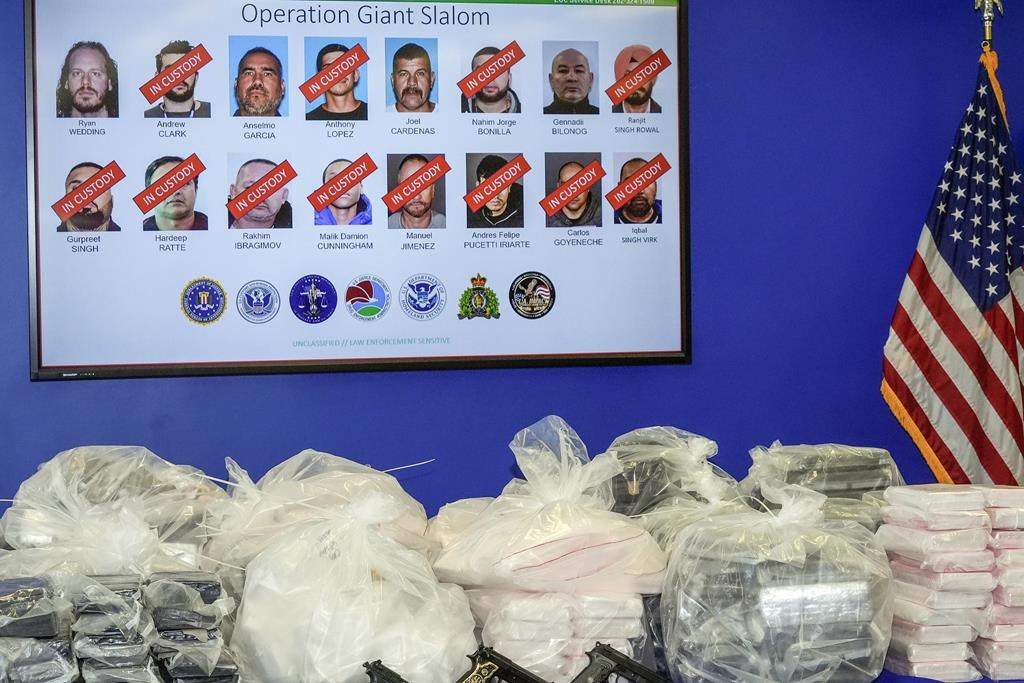 Photos of Ryan Wedding and 15 other defendants who have been charged with allegedly running and participating in a transnational drug trafficking operation displayed on a FBI video monitor in Los Angeles, Thursday, Oct. 17, 2024.