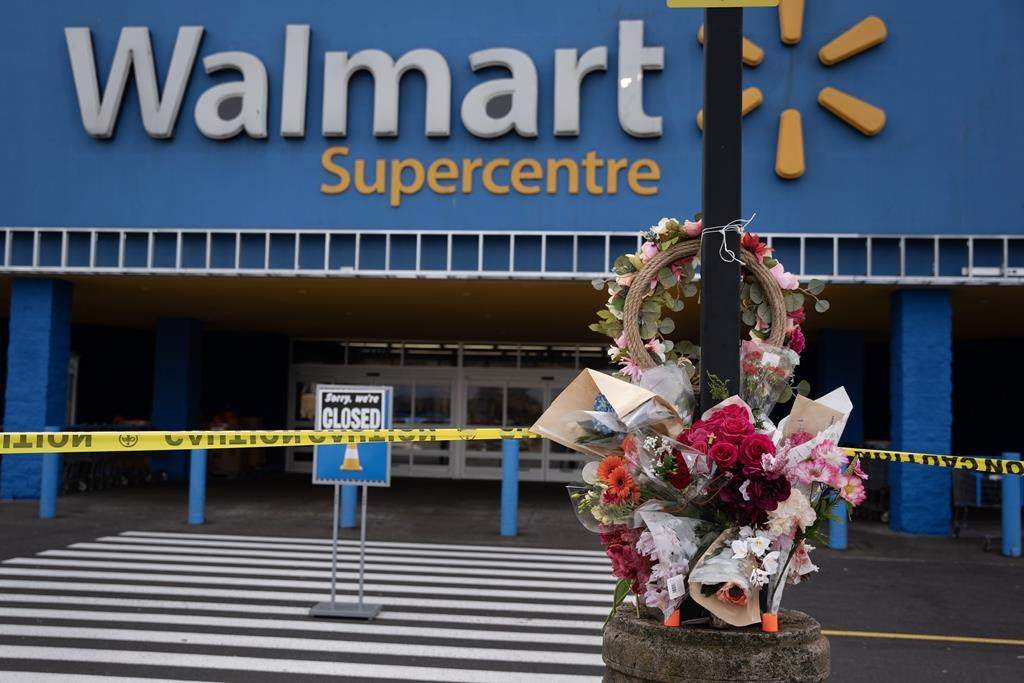 A Walmart remains closed as a vigil grows outside the taped-off area in Halifax on Wednesday, Oct. 23, 2024 following the death of a 19-year-old employee last weekend.  THE CANADIAN PRESS/Darren Calabrese