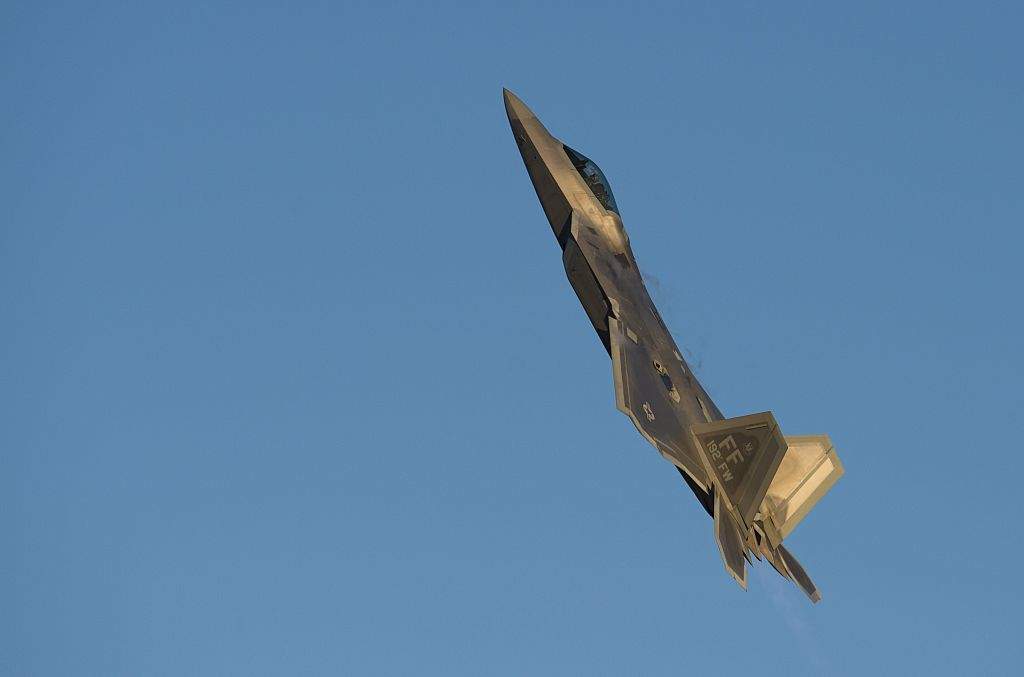 A US Air Force Lockheed Martin F-22 Raptor stealth fighter aircraft performs a demonstration flight during the inaugural Trilateral Exercise between the US Air Force, United Kingdom's Royal Air Force and the French Air Force at Joint Base Langley-Eustis in Hampton, Virginia, December 15, 2015.