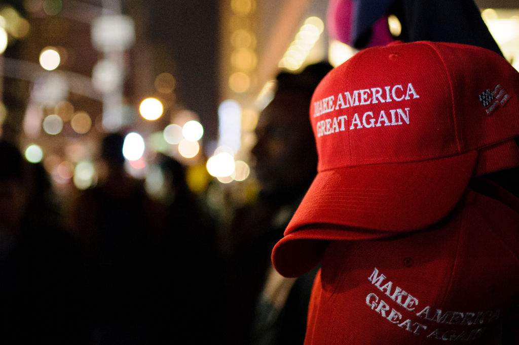 FILE - "Make America Great Again" red baseball caps, signature headwear of the Donald Trump campaign and its supporters, stand on sale in New York City.