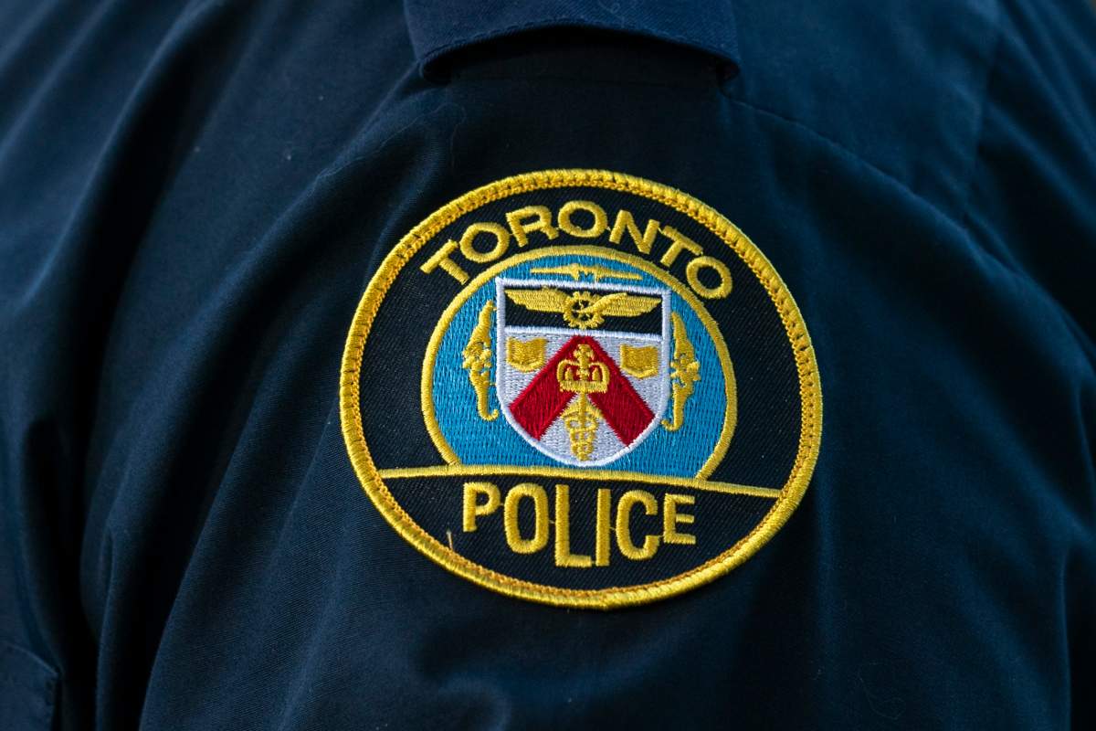 A Toronto Police Service logo patch is shown in Toronto