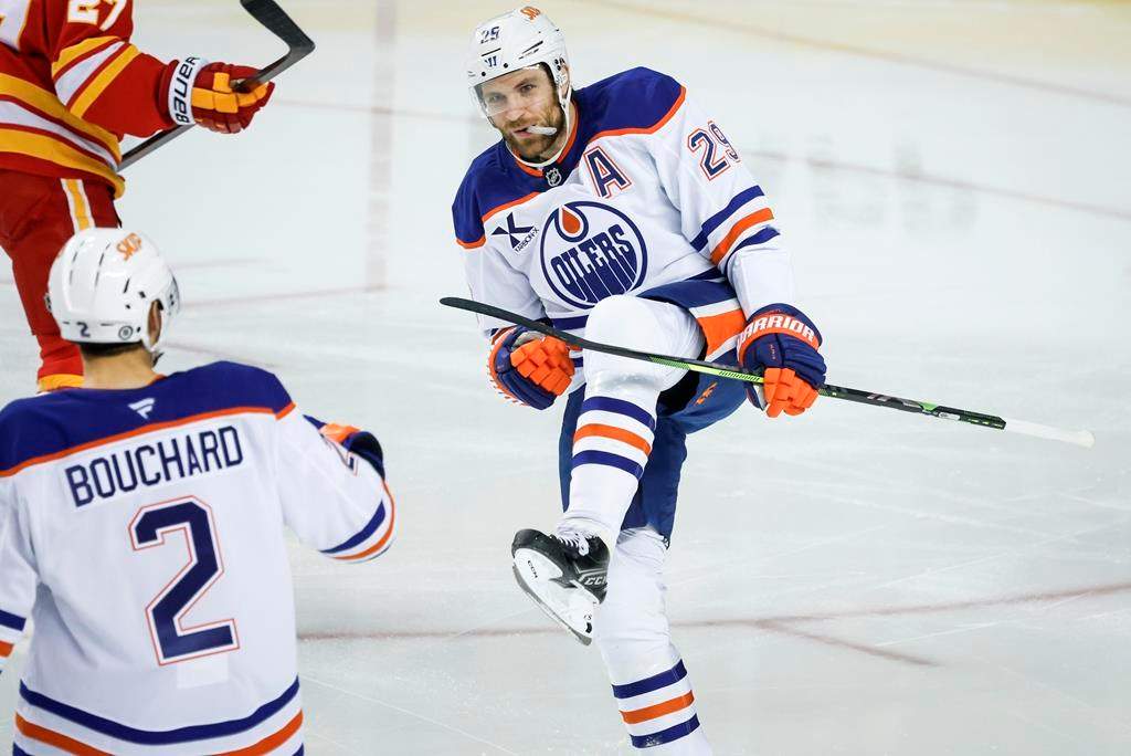 Edmonton Oilers’ Leon Draisaitl, right, celebrates his goal with teammate Evan Bouchard during first period NHL hockey action against the Calgary Flames in Calgary on Sunday, Nov. 3, 2024.