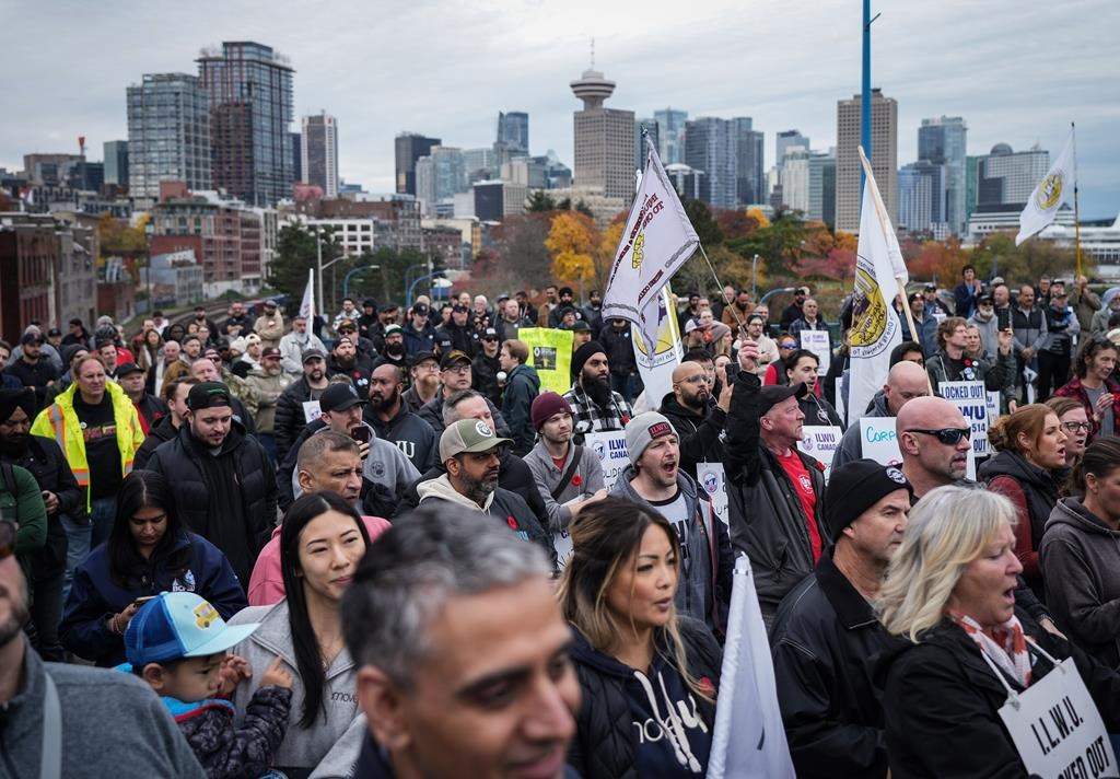 B.C workers stand outside a port during multi-day lockout.