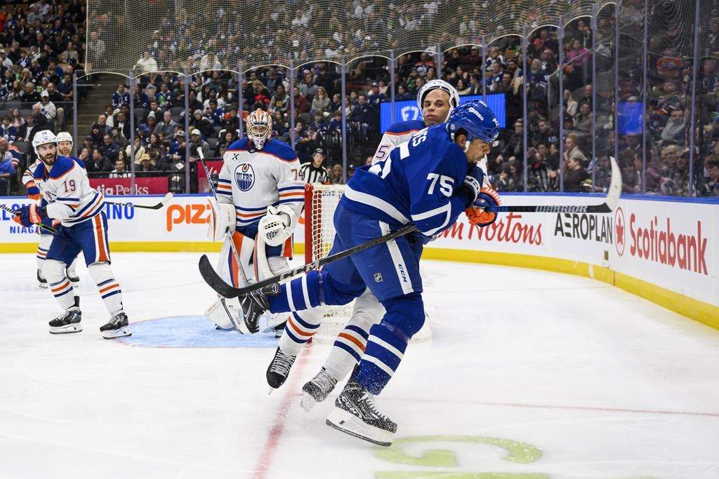 Toronto Maple Leafs right wing Ryan Reaves (75) collides with Edmonton Oilers defenceman Darnell Nurse (25) during second period NHL hockey action, in Toronto, Saturday, Nov. 16, 2024.