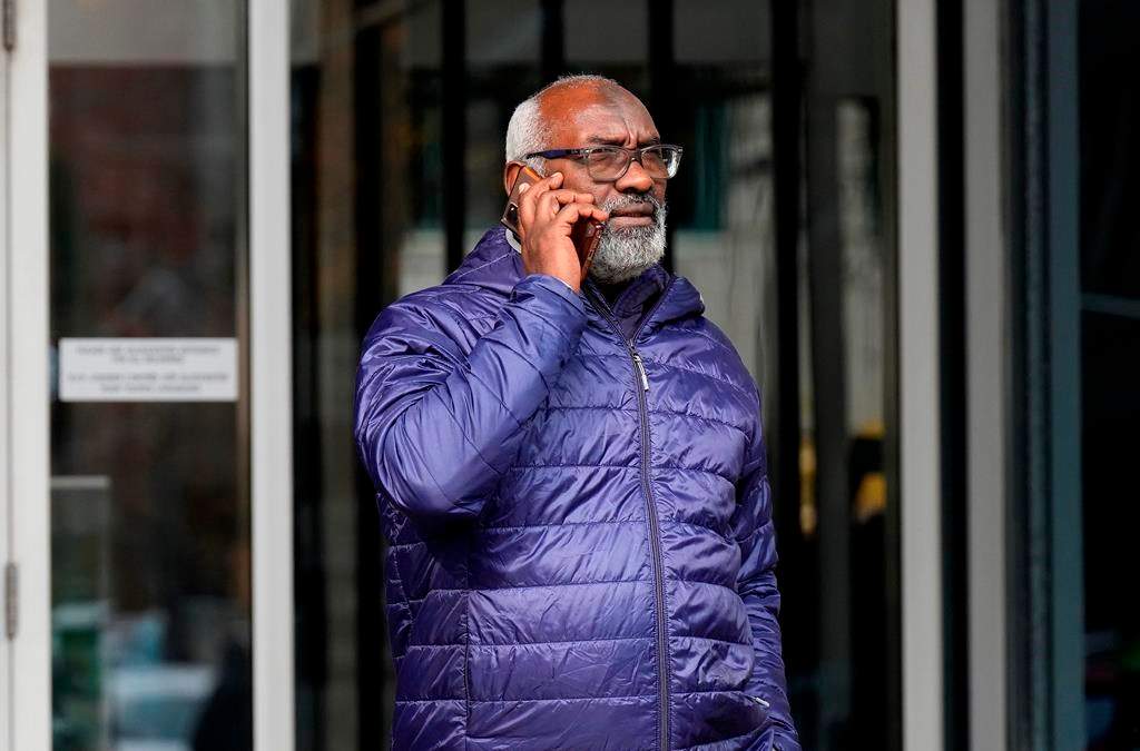 Abousfian Abdelrazik speaks on the phone as he leaves the a building where his case is being heard in Federal Court in Ottawa on October 30, 2024. THE CANADIAN PRESS/Adrian Wyld.