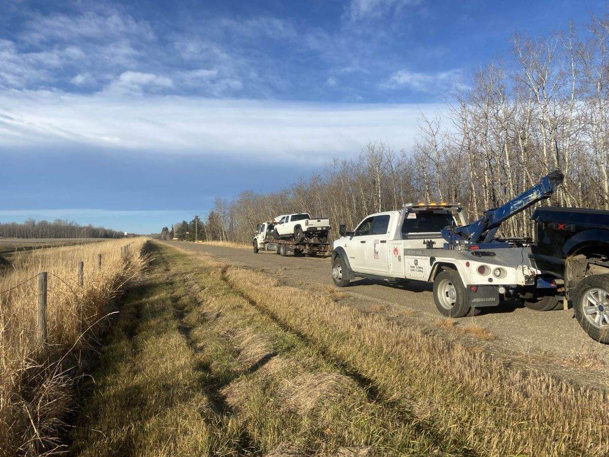 A truck is seen towing away a vehicle involved in a crash in Strathcona County in Alberta on Nov. 8, 2024.
