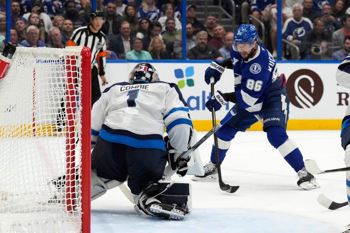 Tampa Bay Lightning right wing Nikita Kucherov (86) shoots on Winnipeg Jets goaltender Eric Comrie (1) during the second period of an NHL hockey game Thursday, Nov. 14, 2024, in Tampa, Fla. (AP Photo/Chris O'Meara).