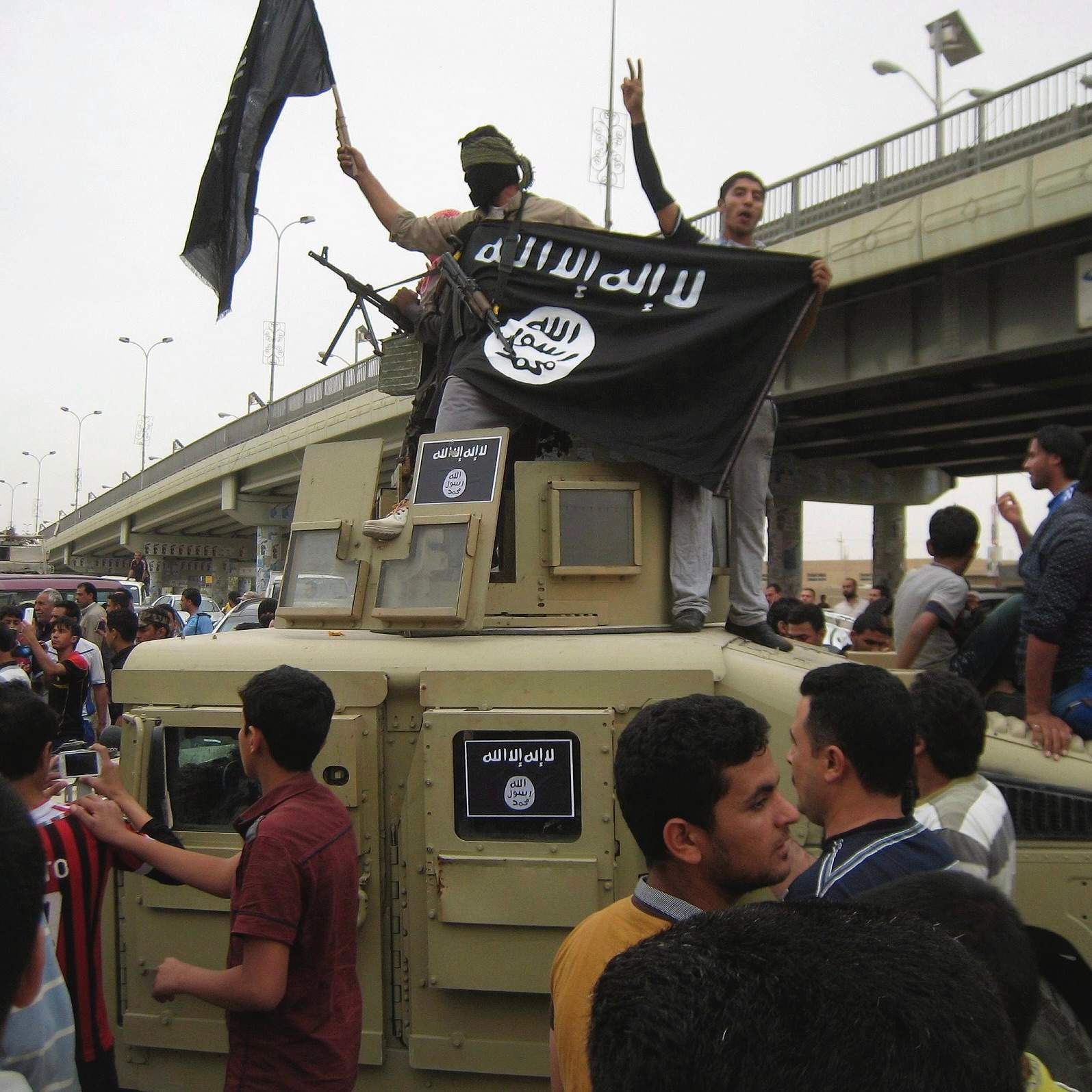 ISIS militants hold up their flag in Fallujah, Iraq, March 30, 2014, file photo, Islamic State. (AP Photo, File)