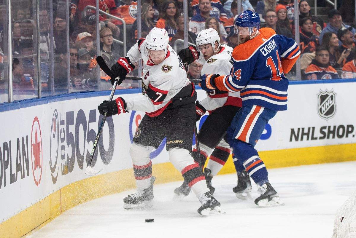 Ottawa Senators' Brady Tkachuk (7), Josh Norris (9) and Edmonton Oilers' Mattias Ekholm (14) battle for the puck during first period NHL action in Edmonton on Saturday January 6, 2024.