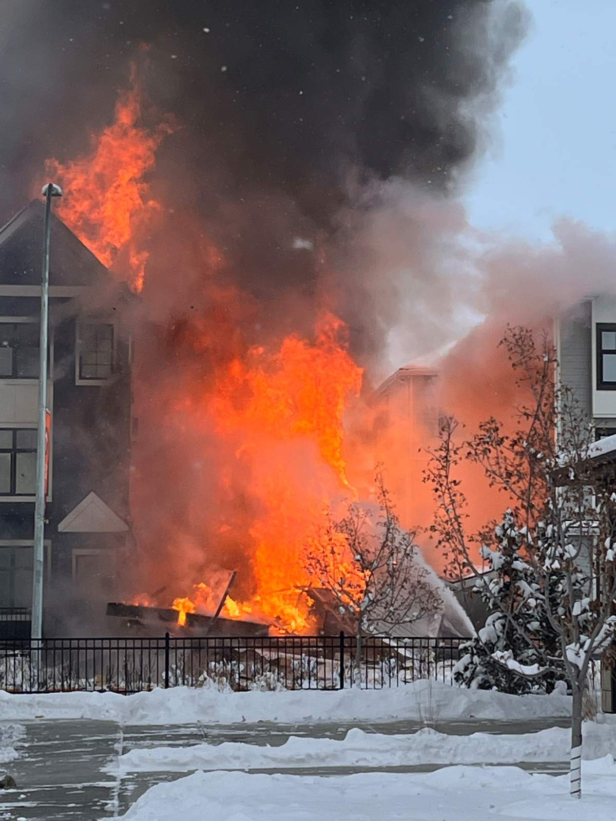 Photos provided to Global News show a wall of flames coming from a collapsed townhouse in the community of Mahogany on Nov. 21, 2024.