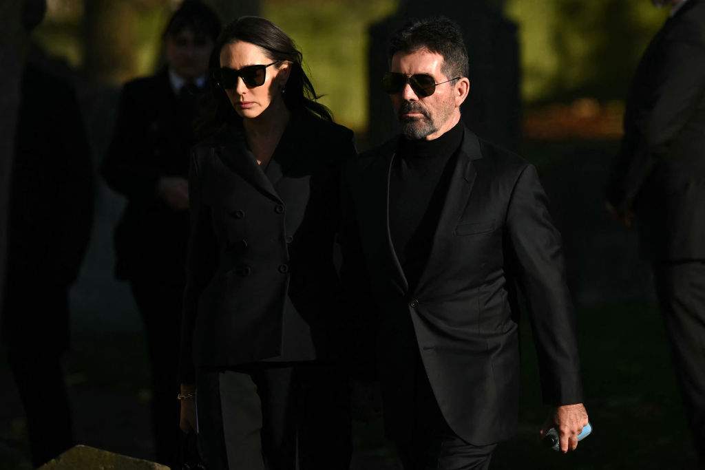 Simon Cowell (R) and Lauren Silverman leave after attending the funeral service of the late One Direction singer Liam Payne, at a St Mary's church in Amersham, west of London on November 20, 2024.