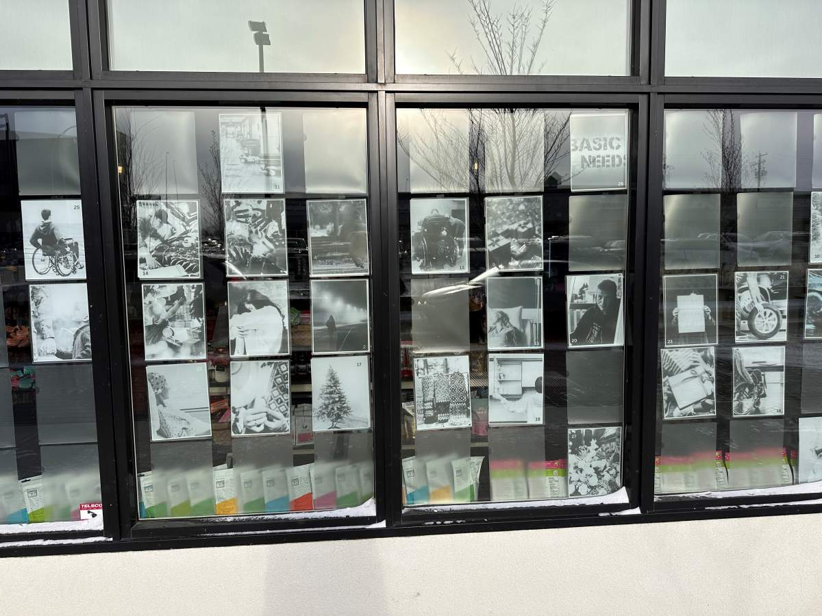 Stories posted on the windows of Brickhouse Smokery showing people in need this holiday season in Spruce Grove, Alta.