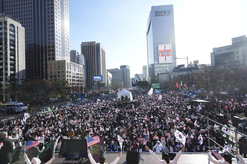 People gather during a rally held by conservative groups supporting South Korean President Yoon Suk Yeol and denouncing opposition parties’ lawmakers who demanding impeachment of the president, in Seoul, South Korea, Saturday, Dec. 7, 2024, following the president’s short-lived martial law declaration. (AP Photo/Lee Jin-man)