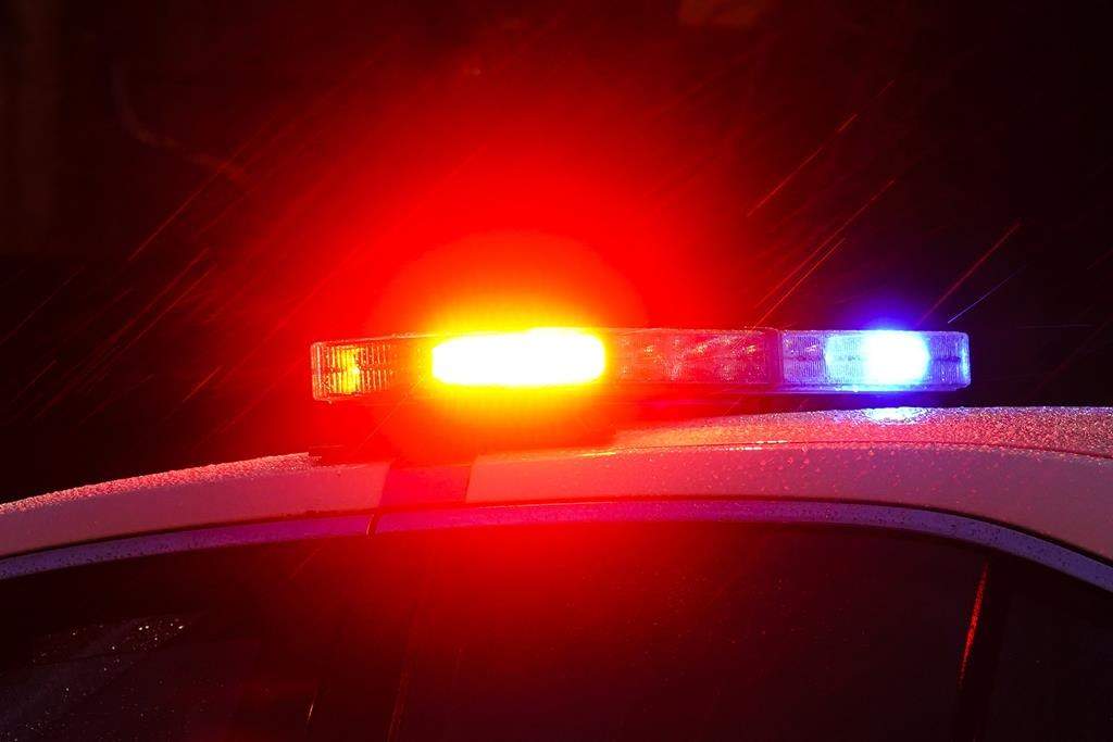 A police car with flashing lights is shown. 