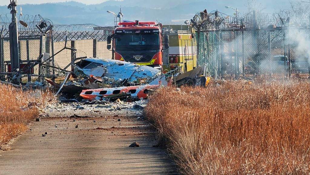 Fire engines work to extinguish a fire at the Muan International Airport in Muan, South Korea, Sunday, Dec. 29, 2024.