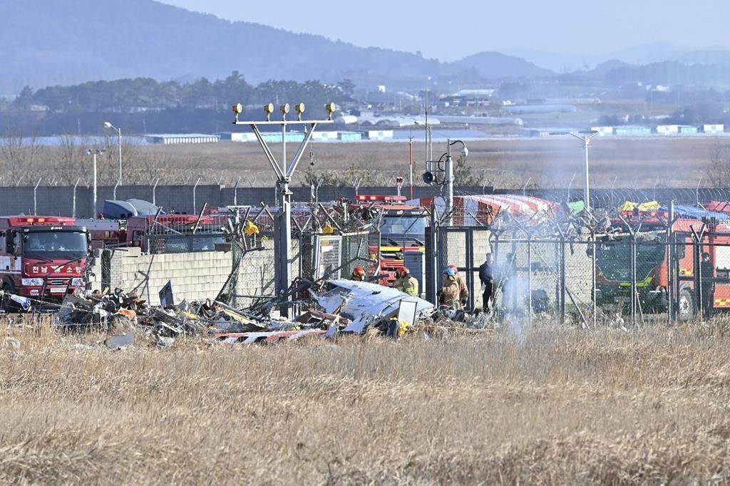 Firefighters and rescue team members work at Muan International Airport in Muan, South Korea, Sunday, Dec. 29, 2024.