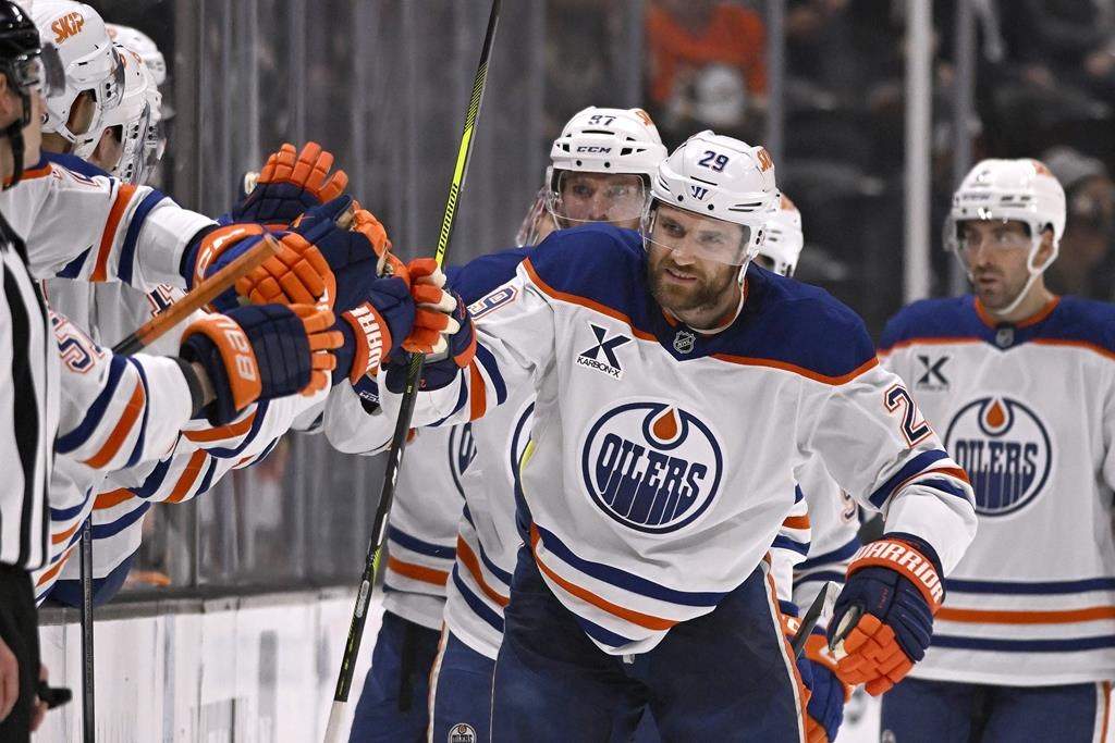 Edmonton Oilers centre Leon Draisaitl (29) celebrates with teammates after scoring against the Anaheim Ducks during the second period of an NHL hockey game in Anaheim, Calif., Sunday, Dec. 29, 2024.