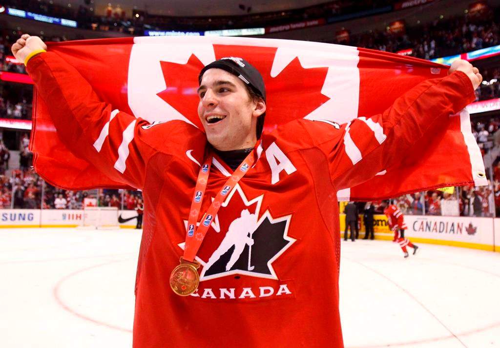 FILE - Canada's John Tavares holds up a Canadian flag after beating Sweden in the final at the world junior hockey championship in Ottawa on Monday, Jan. 5, 2009. 