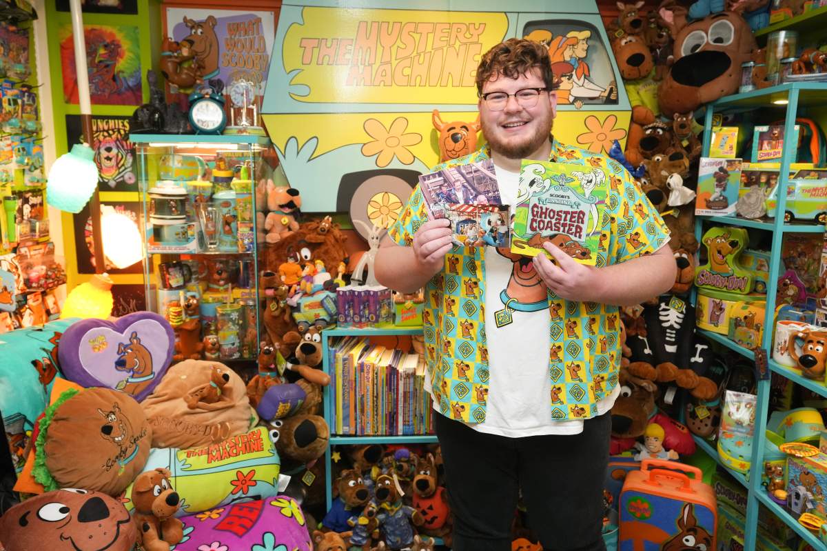 Tristan Sacrey poses with some of the Scooby Doo merchandise he has collected with his partner Brad Flowers, in their Brampton, Ontario home on Sunday November 24, 2024.THE CANADIAN PRESS/Chris Young