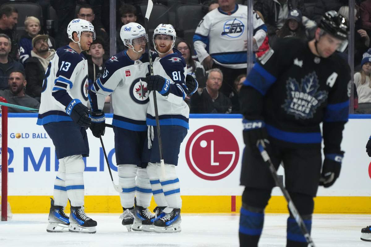 Winnipeg Jets left wing Kyle Connor (81) celebrates with teammates centre Gabriel Vilardi (13) and left wing Kyle Connor (81) after scoring