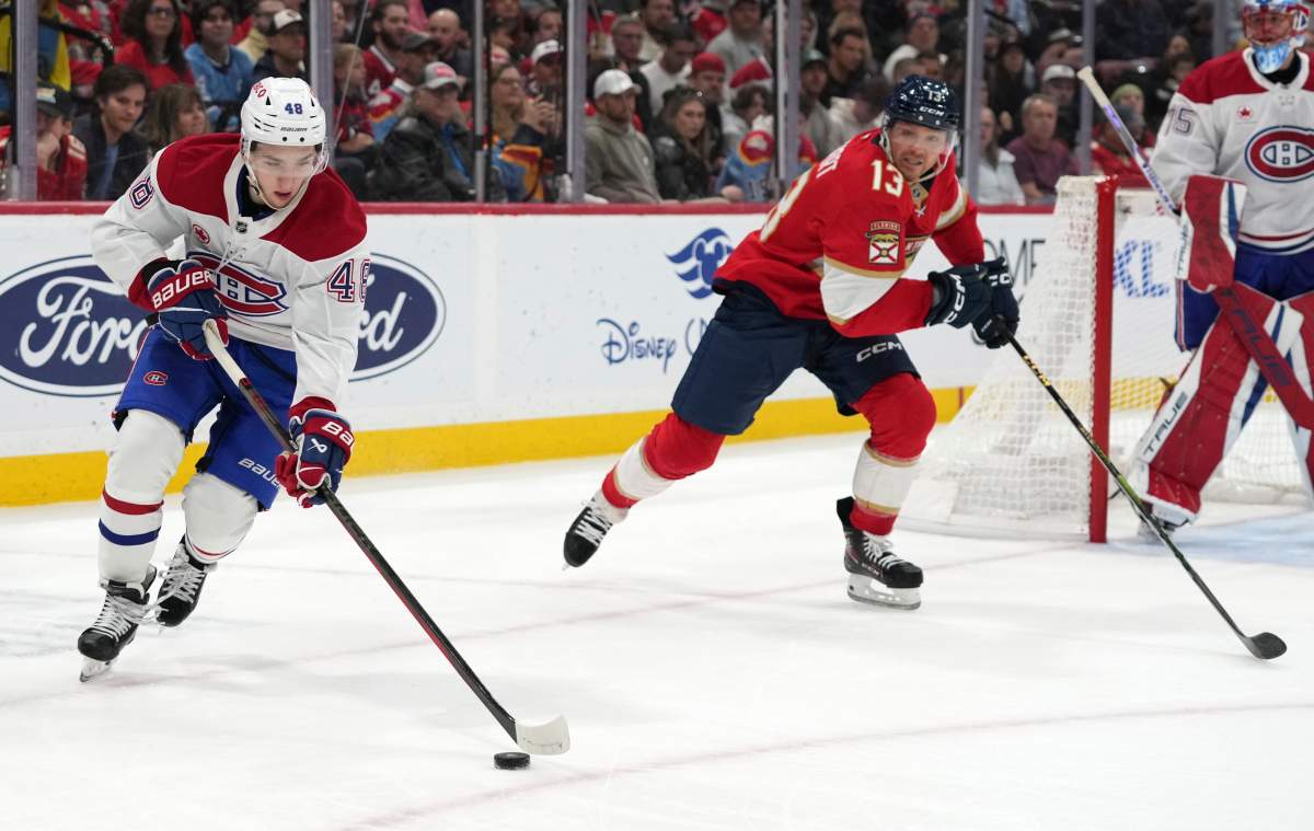 Montreal Canadiens defenseman Lane Hutson (48) skates with the puck as Florida Panthers center Sam Reinhart (13) pursues during the second period of an NHL hockey game, Saturday, Dec. 28, 2024, in Sunrise, Fla. 