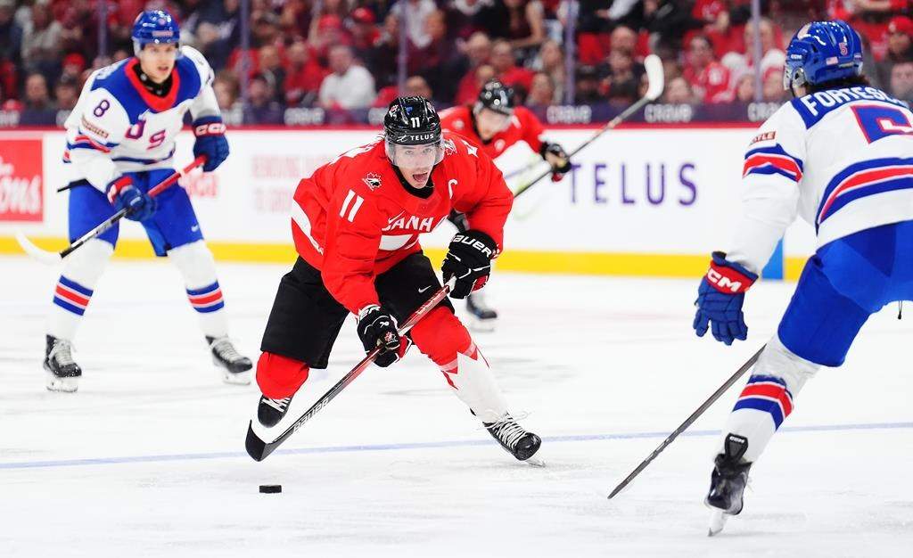 Canada's Brayden Yager (11) skates with the puck as USA's Drew Fortescue (5) defends during second period IIHF World Junior Hockey Championship tournament action in Ottawa on Tuesday, Dec. 31, 2024. THE CANADIAN PRESS/Sean Kilpatrick.