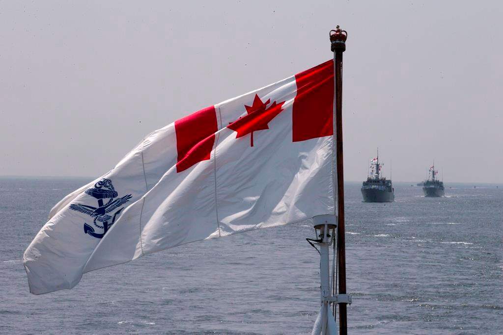 The Royal Canadian Navy Ensign flies during the Parade of Ships entering the New York Harbor, Wednesday, May 25, 2016. The Royal Canadian Navy says a sailor has died in the Bedford Basin after a boat capsized. THE CANADIAN PRESS/AP-Mary Altaffer.
