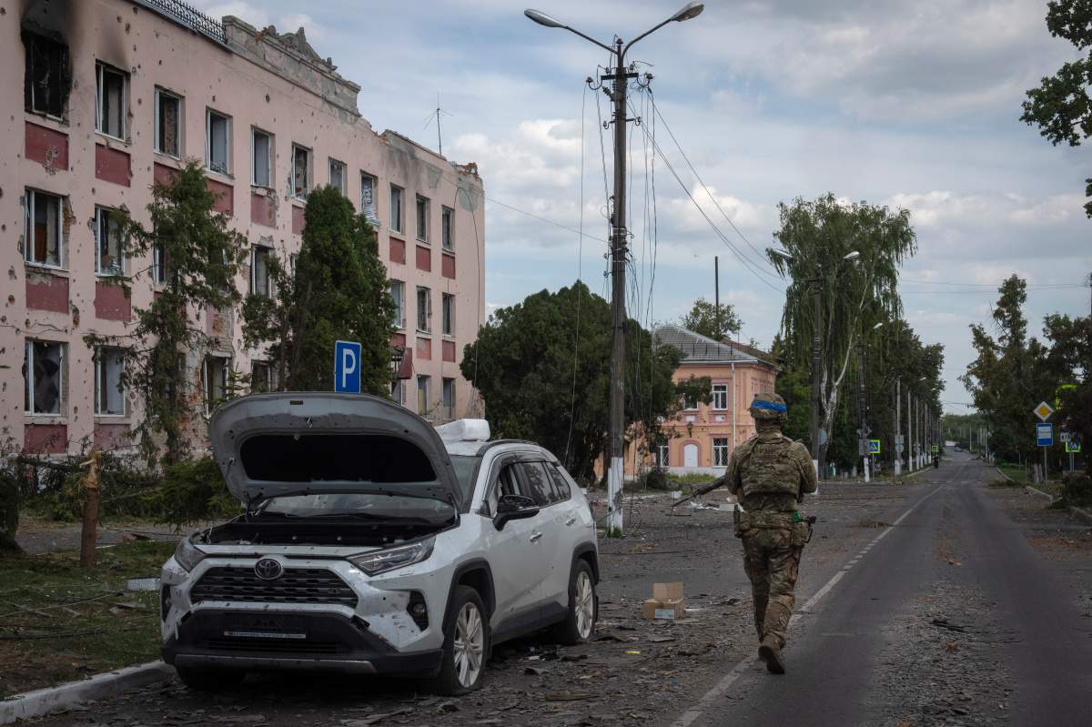 A Ukrainian soldier walks past a building in Sudzha, Kursk region, Russia, on Aug. 16, 2024. This image was approved by the Ukrainian Defense Ministry before publication. (AP Photo, File)