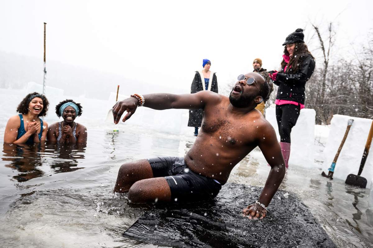 Frank Iteriteka clambers out of the icy waters of Gatineau Park’s Meech Lake in Chelsea, Que., during a polar bear dip on New Year’s Day, Wednesday, Jan. 1, 2025. THE CANADIAN PRESS/Justin Tang