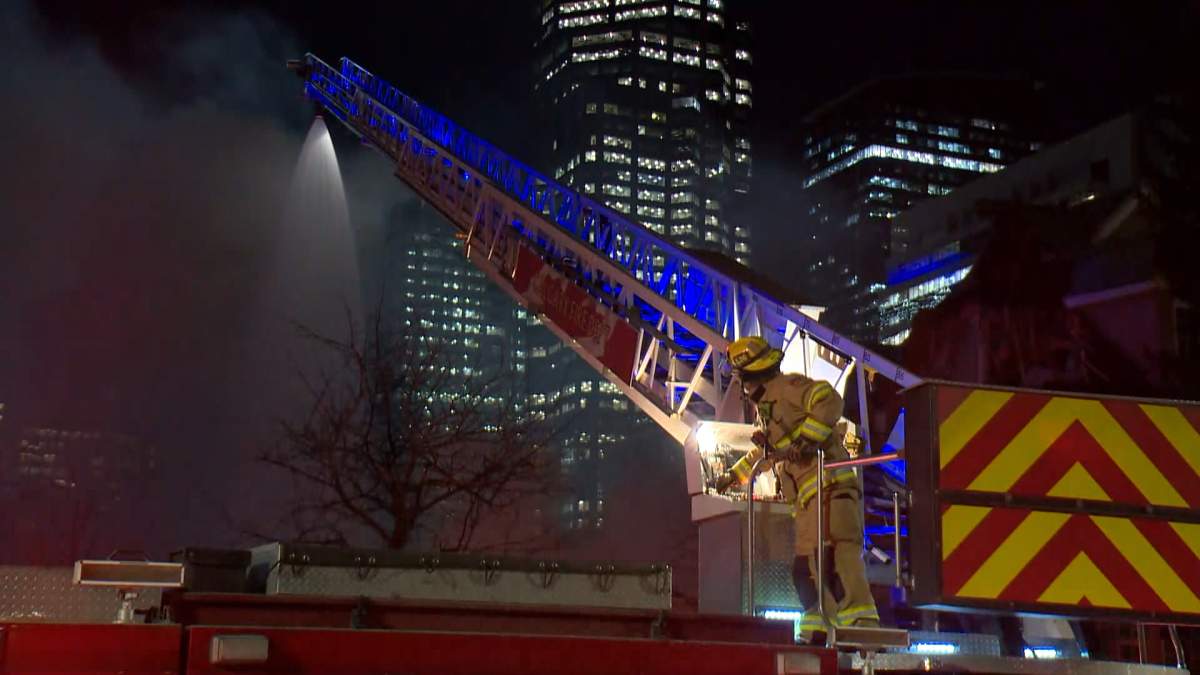 A condo complex in Calgary's Eau Claire area that had already been fenced off and was set to be demolished caught fire on Tuesday night.