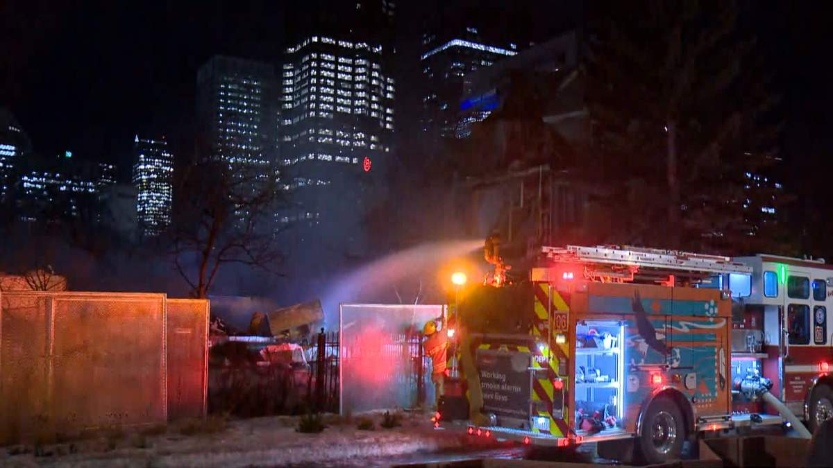 A condo complex in Calgary's Eau Claire area that had already been fenced off and was set to be demolished caught fire on Tuesday night.