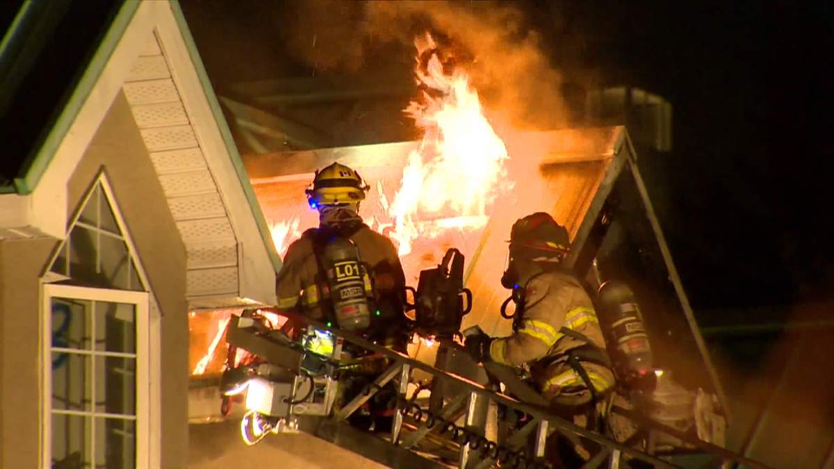 A condo complex in Calgary's Eau Claire area that had already been fenced off and was set to be demolished caught fire on Tuesday night.