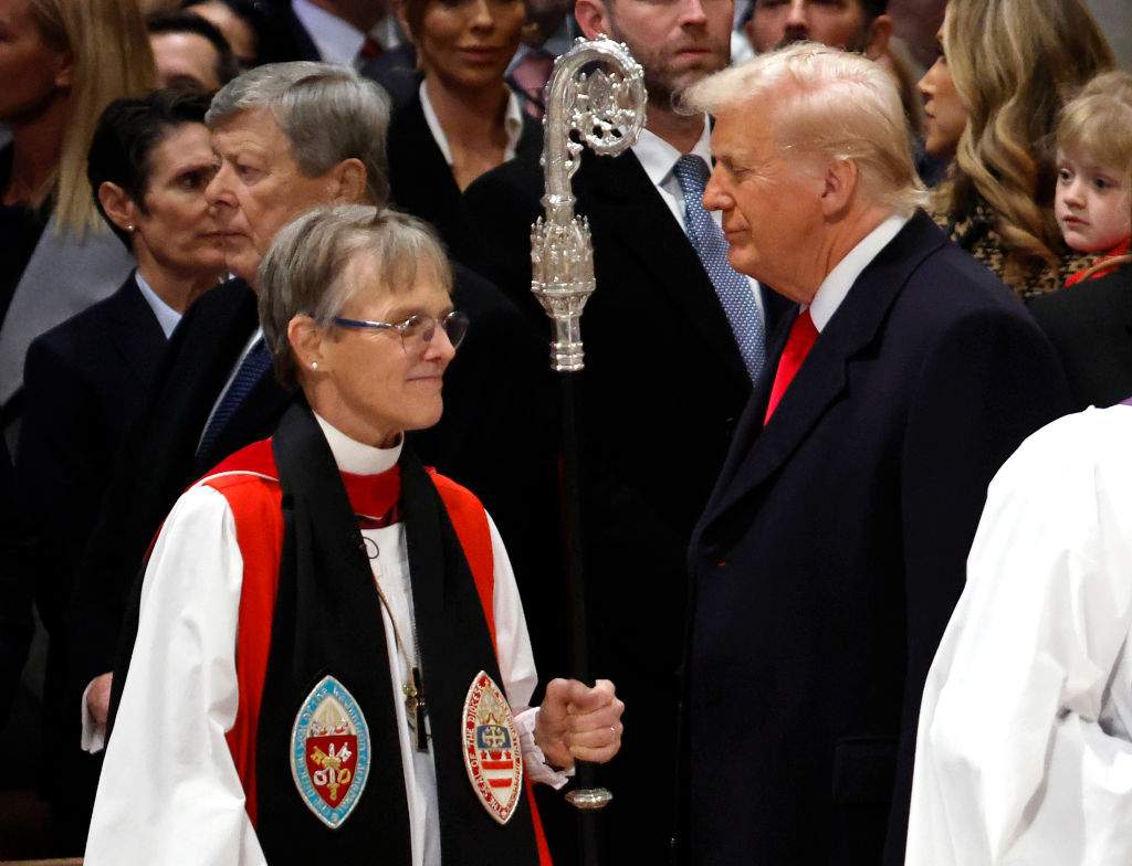 Bishop Mariann Edgar Budde (L) arrives as U.S. President Donald Trump looks on during the National Prayer Service at Washington National Cathedral on January 21, 2025 in Washington, D.C. Tuesday marks Trump's first full day of his second term in the White House.