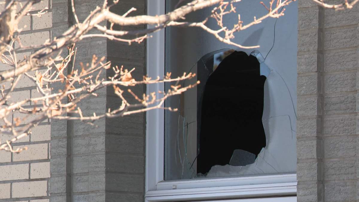 A hole in the window of a Mormon church in SW Calgary after police say someone threw a a molotov cocktail at the building early in the morning of Thursday, Jan. 9, 2025.