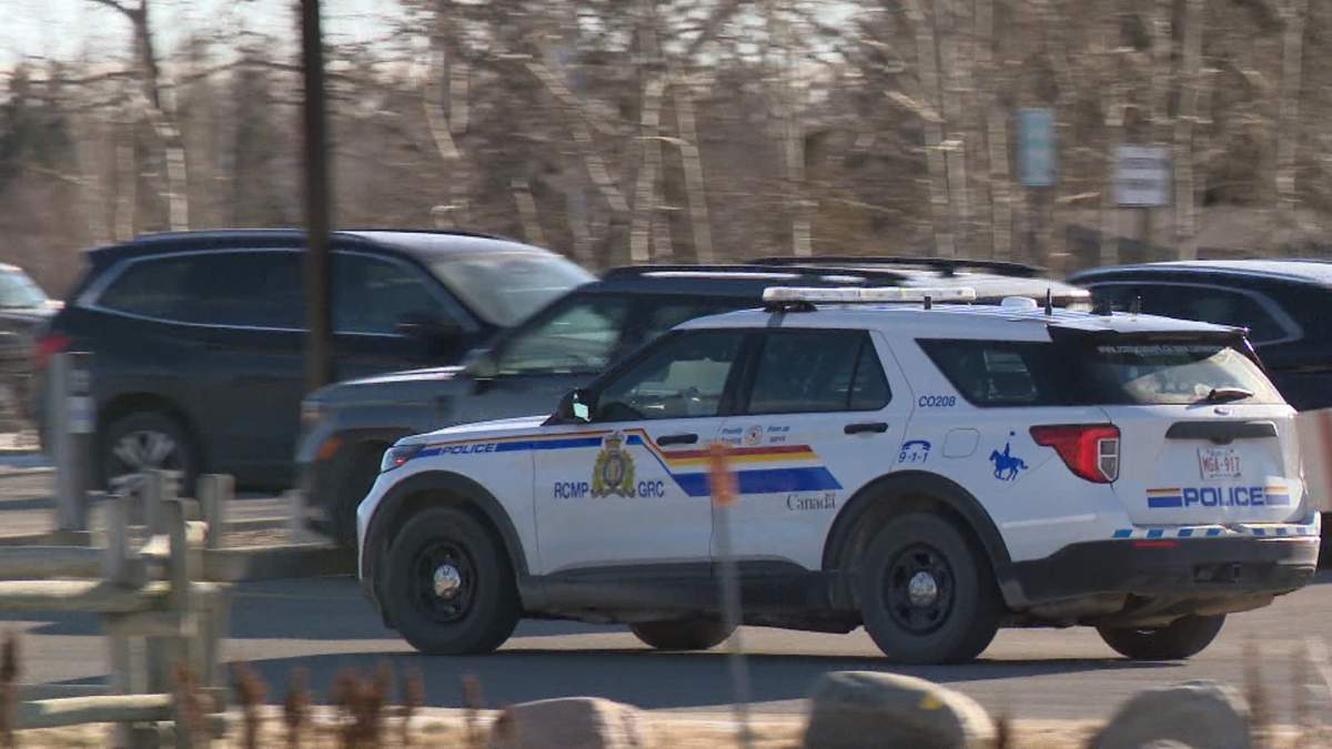 An RCMP cruiser is seen in the parking lot of Springbank high school on Wednesday, a day after a teacher at the school was arrested on allegations of sexual offences against a female student.