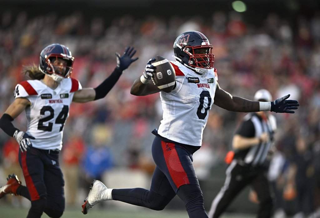 Montreal Alouettes defensive end Shawn Lemon (0) scores a touchdown after a fumble by Ottawa Redblacks quarterback Dustin Crum, not shown, during second half CFL football action in Ottawa on Sept. 30, 2023.